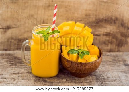 Mango Fruit And Mango Cubes On The Wooden Table