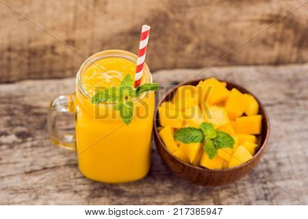 Mango Fruit And Mango Cubes On The Wooden Table