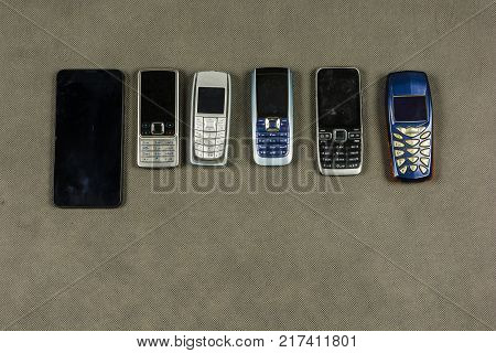 Selection of various mobile phones and a smartphone.
