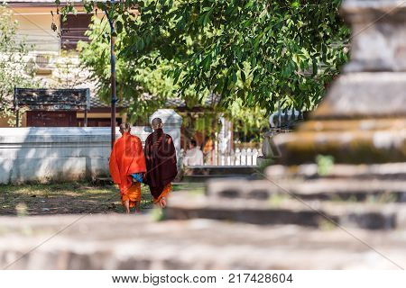 Two Buddhist Monks On The Street Louangphabang Laos. Back View. With Selective Focus