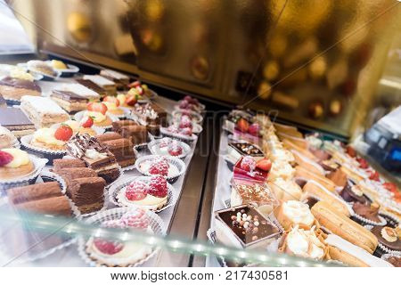 Lots of colorful and tasteful cakes in a patisserie shop delicious cakes