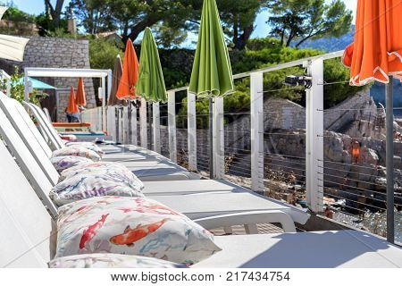 terrace in cafe on the beach with daybed and umbrellas