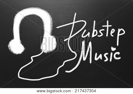Dubstep music text and Drawn witch chalk earphones on blackboard
