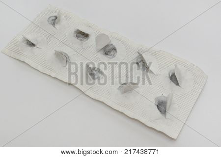 pills plate of remedy for food poisoning. all tablets of activated charcoal taken, paper torn, black dust left