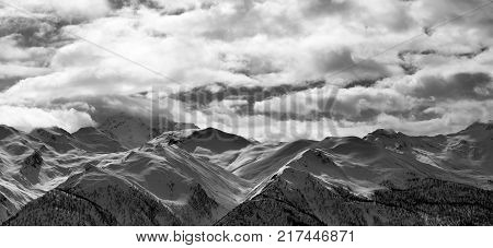 Black and white panoramic view on snowy mountains and cloudy sky in evening. Caucasus Mountains. Svaneti region of Georgia.