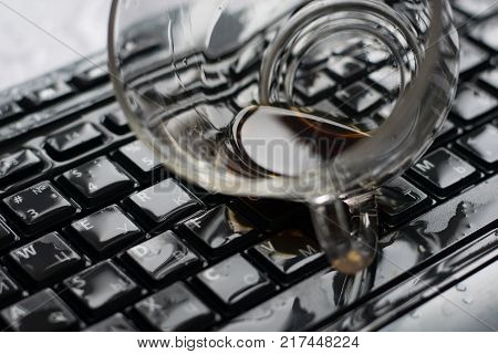 coffe spilled on a computer keyboard close-up