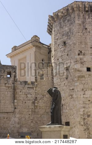 SPLIT, CROATIA - AUGUST 11 2017: Ancient surrounding walls of Split city with the monument to the poet