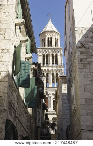 SPLIT, CROATIA - AUGUST 11 2017: Architectural view of Saint Domnius bell tower through buildings windows