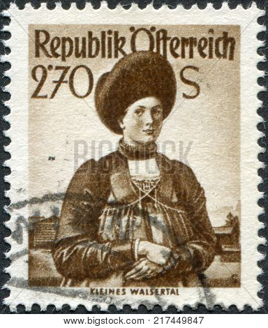 AUSTRIA - CIRCA 1951: A stamp printed in Austria shows a woman in national dress Little Walser Valley circa 1951