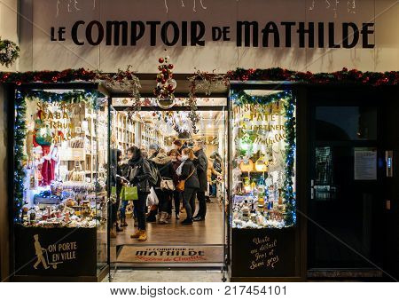 STRASBOURG FRANCE - NOV 29 2017: Le comptoir de Mathilde gourmet souvenir shop in central Strasbourg with people admiring the goods shopping for Christmas