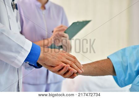 Concept of healing care The doctor is healing old woman.
