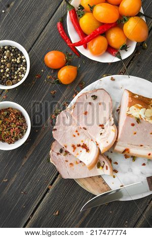 A sliced smoked brisket with spice on a marble cutting board top view