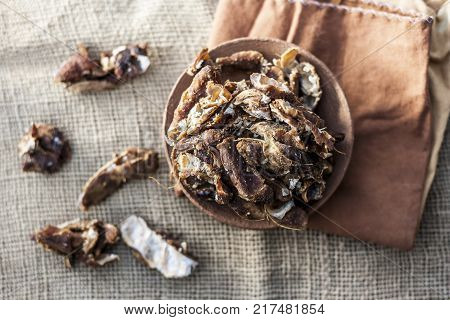 Raw Tamarindus indica,tamarind in a clay bowl on gunny background.