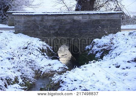 brick bridge over the strudelbach in the lower valley in the community Weissach