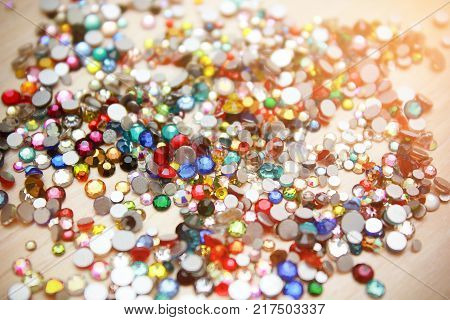 Sparkling rhinestones in the frame. Different color crystals. Handmade ideas.