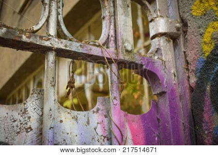 Old tagged gate that has a lot of colors