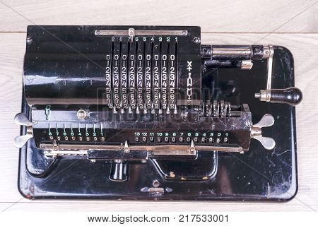 Old Rusty Retro Calculator Black Standing On A Wooden Table