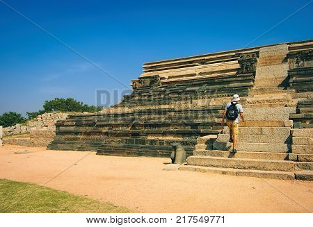 Hampi, India - November 19, 2012: An unidentified tourist climbs the stairs to the platform of Mahanavami Dibba in Hampi, Karnataka, India.