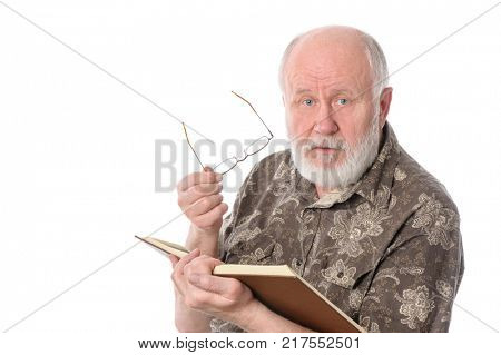 Handsome bald and bearded senior man distracted when reading a book, isolated on white background