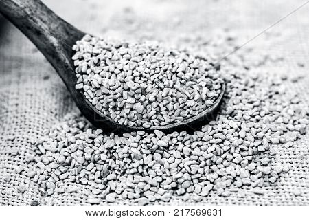 Fenugreek Seeds In A Wooden Scoop On A Gunny Background.