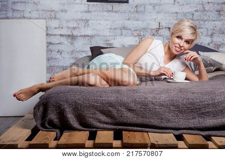 Beautiful Woman Sitting On Leather Sofa