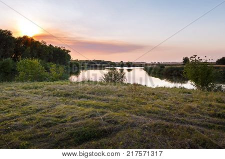 Nature of Central Russia. Summer sunset by the pond.