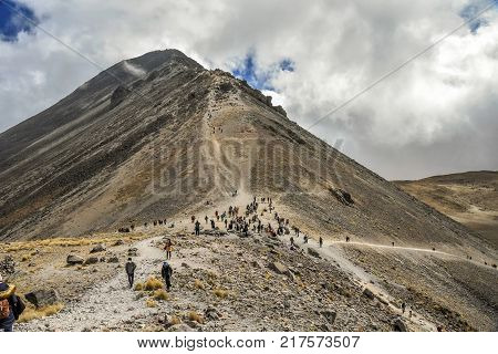 People walking Volcano Nevada de Toluca with lakes inside crater in Mexico