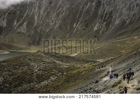 People walking Volcano Nevada de Toluca with lakes inside crater in Mexico