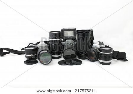 Set of old camera with lenses and a flash camera isolated on white background