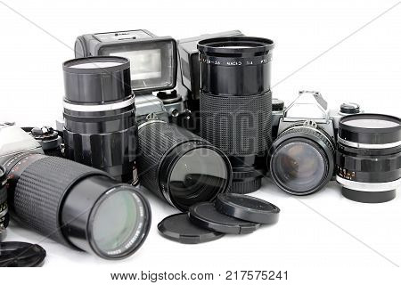 Set of old camera with lenses and a flash camera isolated on white background