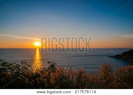 Grass Field in front of the sunset at Leam PromThep Cape in Phuket Amazing Thailand