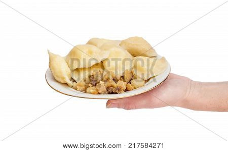 Hand holding bowl with vareniki. Isolated on white.