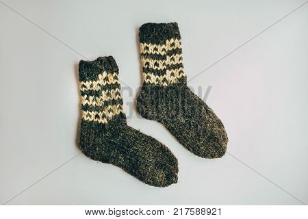 Stack Of Handmade Warm Knitted Socks Scarfs Mittens From Rough Wool Yarn Brown Beige Grey On Wood Ta