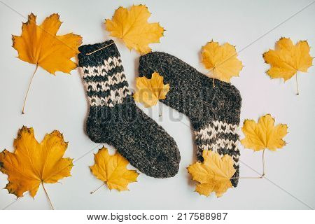 Stack Of Handmade Warm Knitted Socks Scarfs Mittens From Rough Wool Yarn Brown Beige Grey On Wood Ta