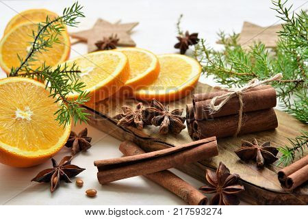 fresh oranges with anisestars, cinnamon sticks, juniper branches. Merry Christmas time composition