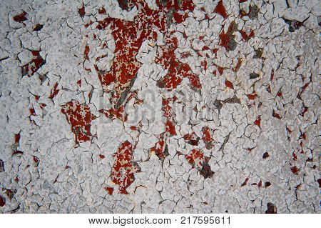 Old grunge texture of cracked red and ehite paint. Macro photo for background