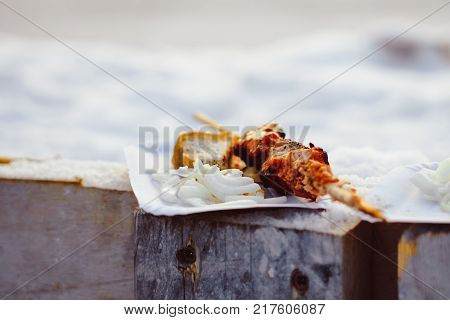 Barbecue cooking - half done kebab of marinated pork, onion and tomatos