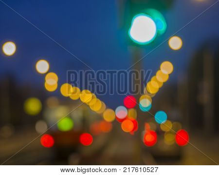 colorful blurred traffic lights with defocused tram and cars during twiling