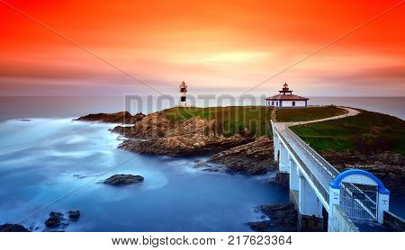 Idyllic view on seashore of Pancha island Spain at sunset of red and orange colors