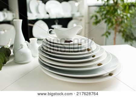 Restaurant white tableware assortment. Stylish crockery set. Purity and luxury concept