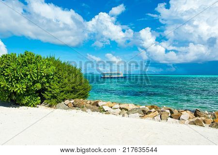 Wooden Maldivian traditional dhoni boat at sunny day on the turquoise Indian ocean water Maldives