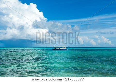 Wooden Maldivian traditional dhoni boat at sunny day on the turquoise Indian ocean water Maldives