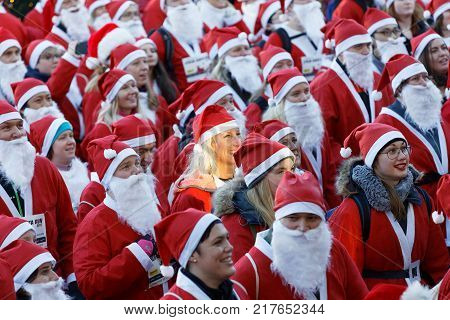 STOCKHOLM SWEDEN - DEC 10 2017: Many Santas in traditional red dresses and beard in the Stockholm Santa Run in Sweden December 10 2017