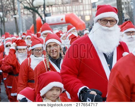 STOCKHOLM SWEDEN - DEC 10 2017: Many Santas in traditional red dresses and beard in the Stockholm Santa Run in Sweden December 10 2017