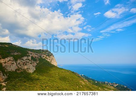 View to the top of the mountain blue sea and cloudy sky