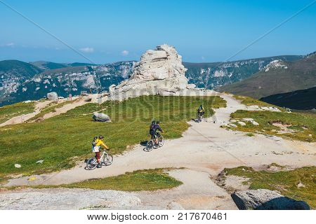 Bucegi Mountains Romania July 09 2015: Unidentified biker climbs the hill in Bucegi Mountains in Romania
