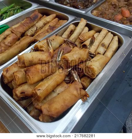 Buffet style of Filipino food in warmers