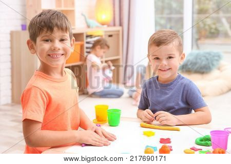 Little boys engaged in playdough modeling at daycare