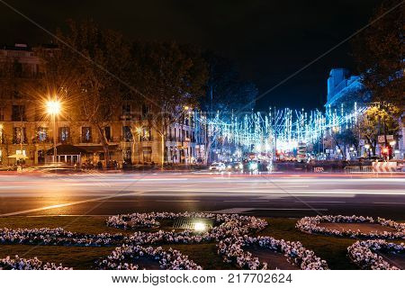 Madrid, Spain - December 8, 2017: Square of Independence in Madrid at night on Christmas Time. Long exposure shot with light trails of traffic