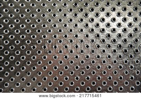 Abstract surface of metal grater as a background